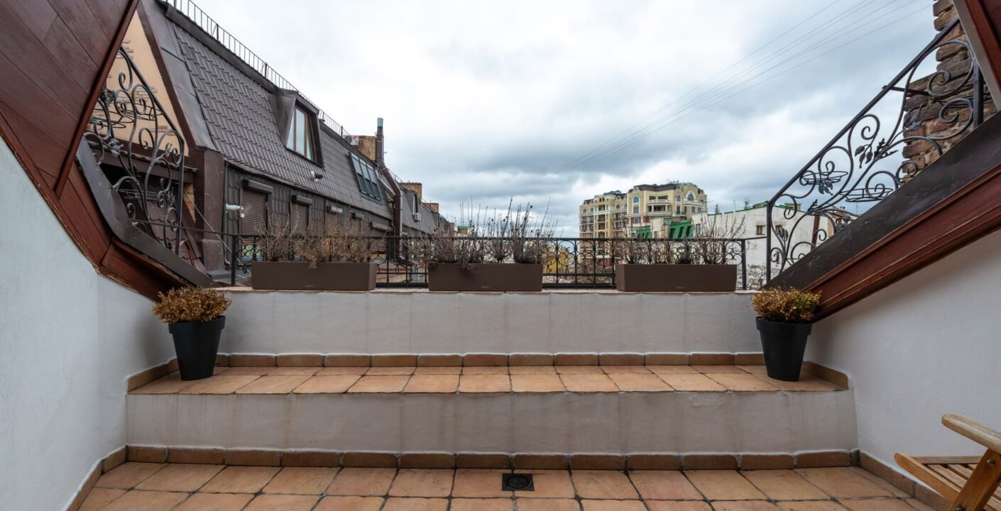 Balkon mit gefliestem Boden, Bodenablauf und Metallgeländer